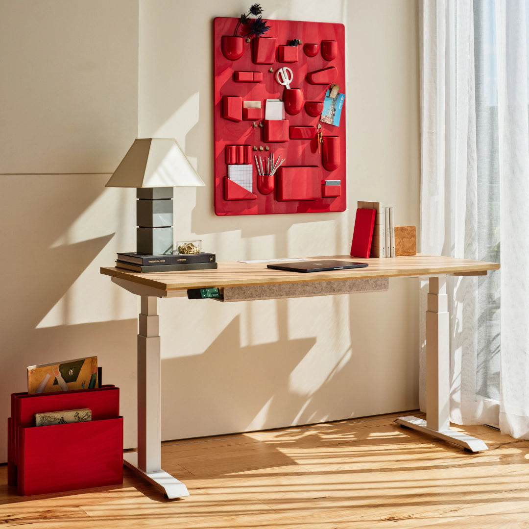 Branch Tria standing desk with Woodgrain laminated-MDF top and White legs; media does not identify selected size.