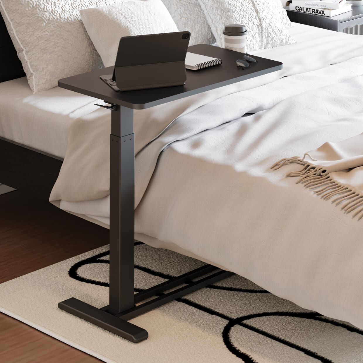 FlexiSpot H7 mobile overbed table with a dark tabletop beside a bed