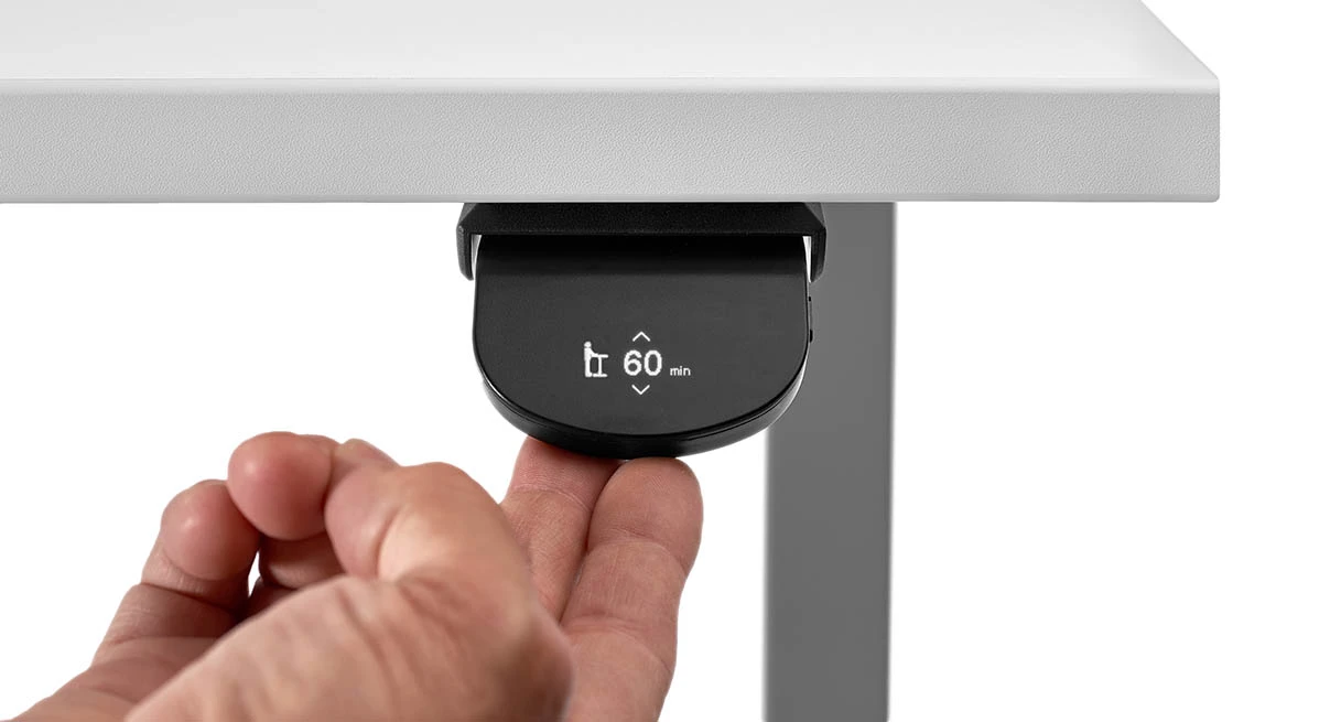 UPLIFT FRM055 paddle controller shown under a desk with a 60-minute reminder indicator
