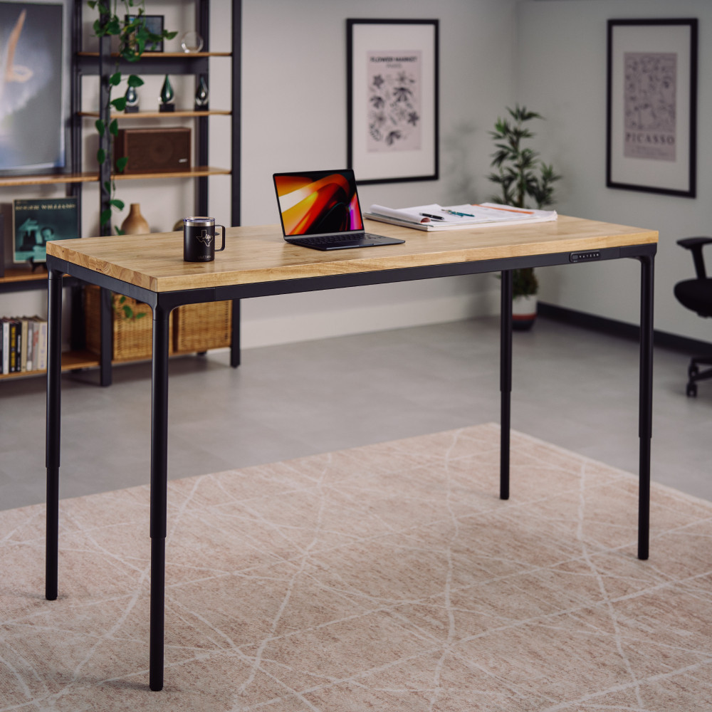 UPLIFT Parsons Standing Desk with black four-leg frame and wood-look desktop; UPLIFT does not identify the selected exact top size or finish
