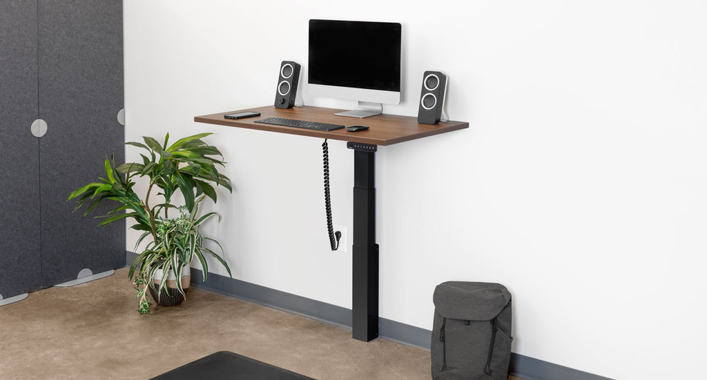 UPLIFT wall-mounted desk family view; the image does not identify this selected walnut top or keypad