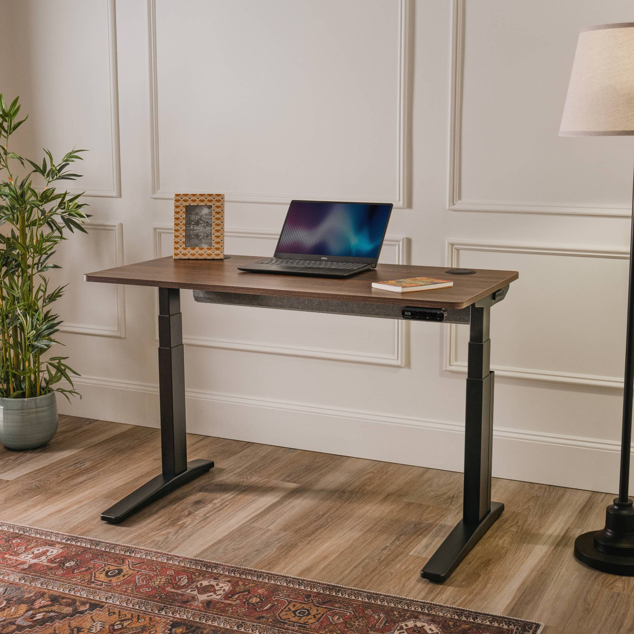 UPLIFT V3 Essential standing desk with a walnut-look desktop and black two-leg frame