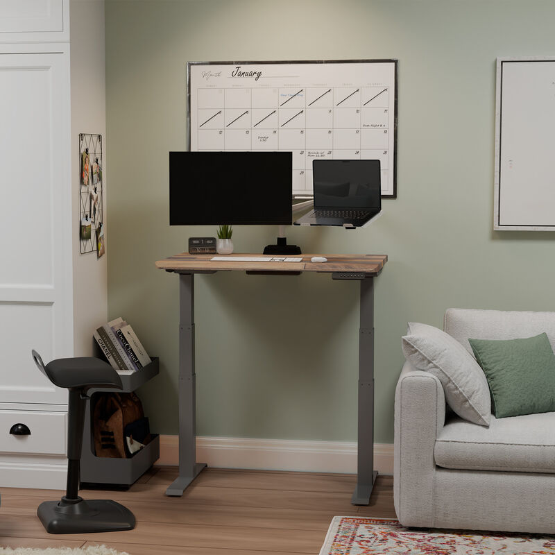 Vari Electric Standing Desk with ComfortEdge 40x26 in Reclaimed Wood/Slate, raised in a staged home office