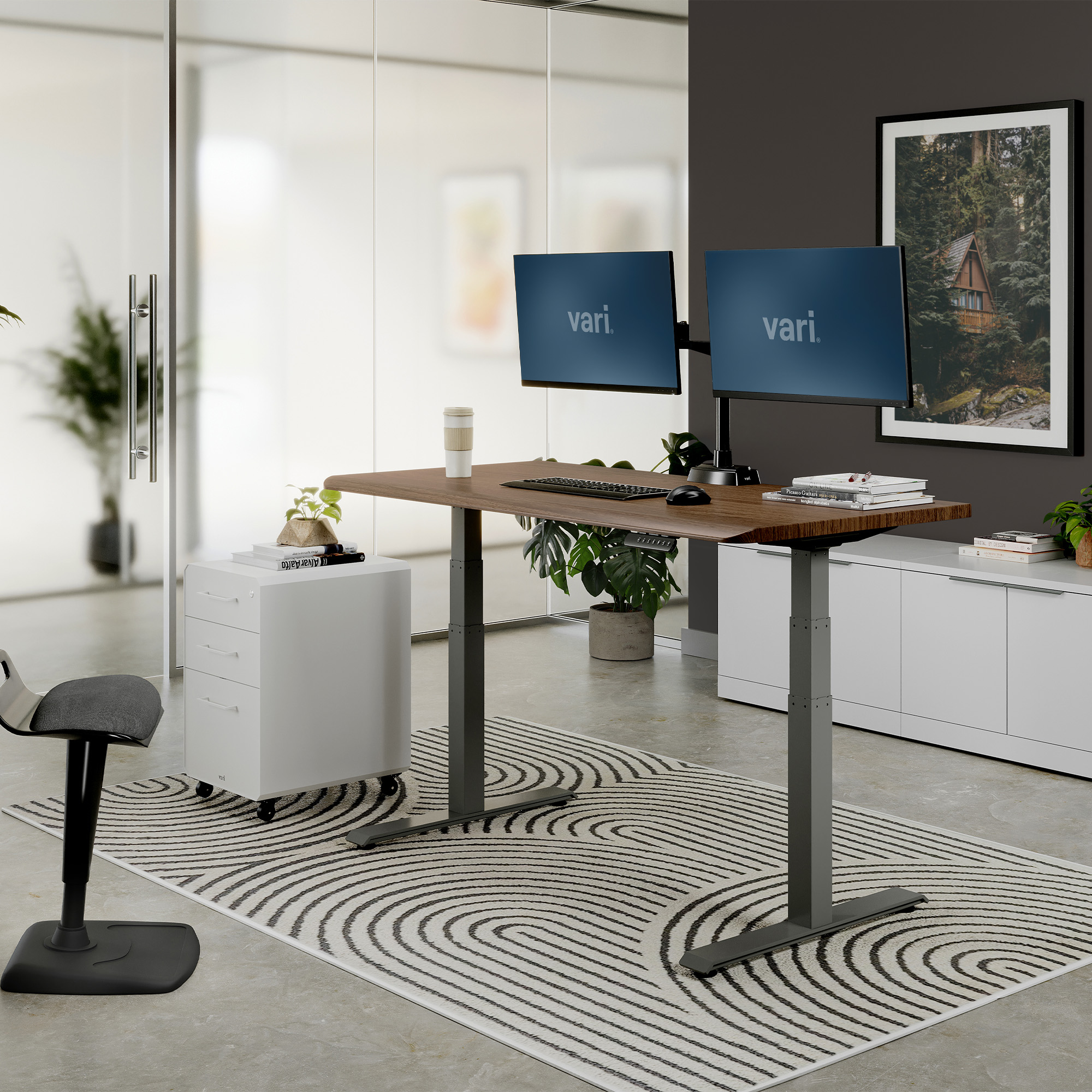Vari ComfortEdge 60x30 electric desk in Walnut/Slate finish, raised in a staged office