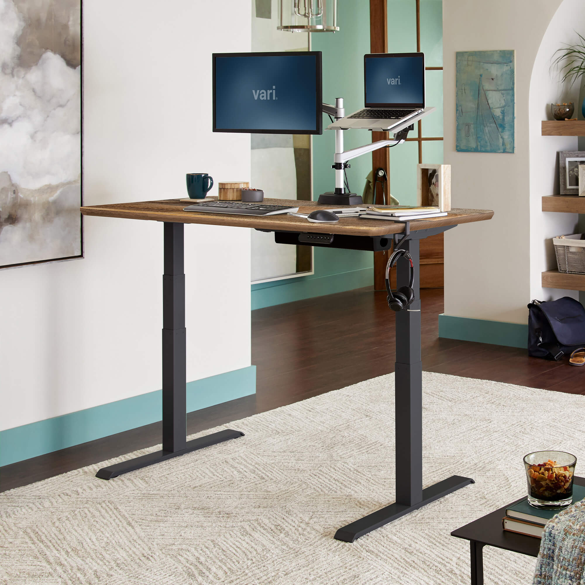 Vari Electric Standing Desk 60x30, Reclaimed Wood/Slate laminate top, raised in a staged workspace