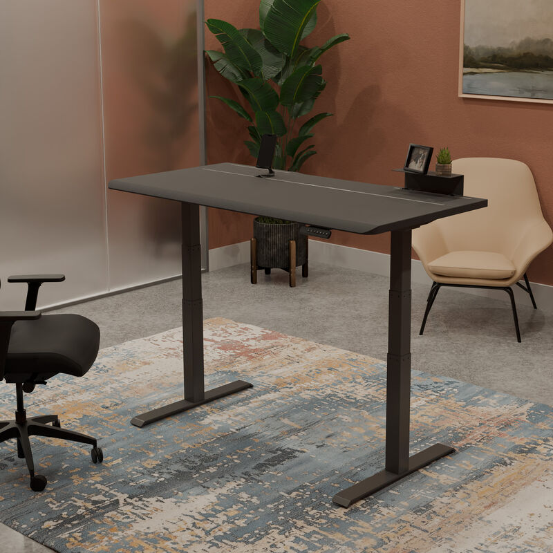 Vari Electric Standing Desk 60x30 with TechTrack in Black/Slate finish, shown in a staged office scene