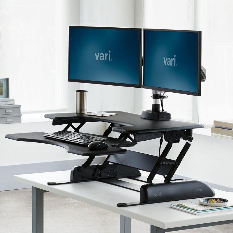 VariDesk Pro Plus 36, black, raised on its linked page image; host desk and staged equipment are not included-item evidence.
